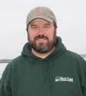 A Rock Coast Plumbing & Heating technician in a company sweatshirt