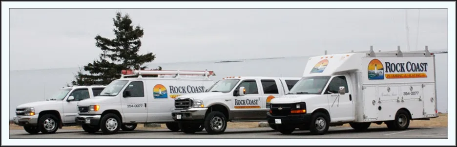 Rock Coast Plumbing & Heating service trucks parked by the water