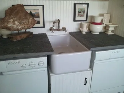Farmhouse sink installation with wall-mounted faucet