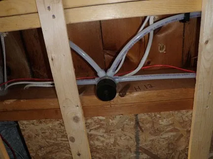 Uponor residential sprinkler piping installed between floor joists