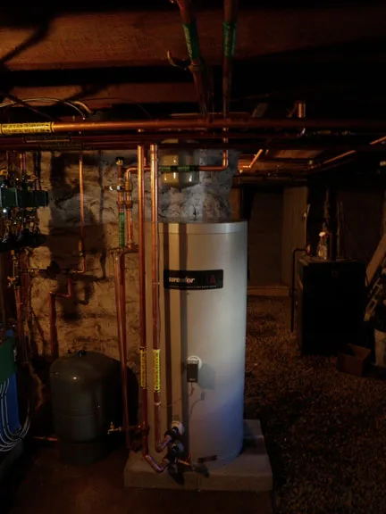 Indirect-fired water heater in a basement mechanical room